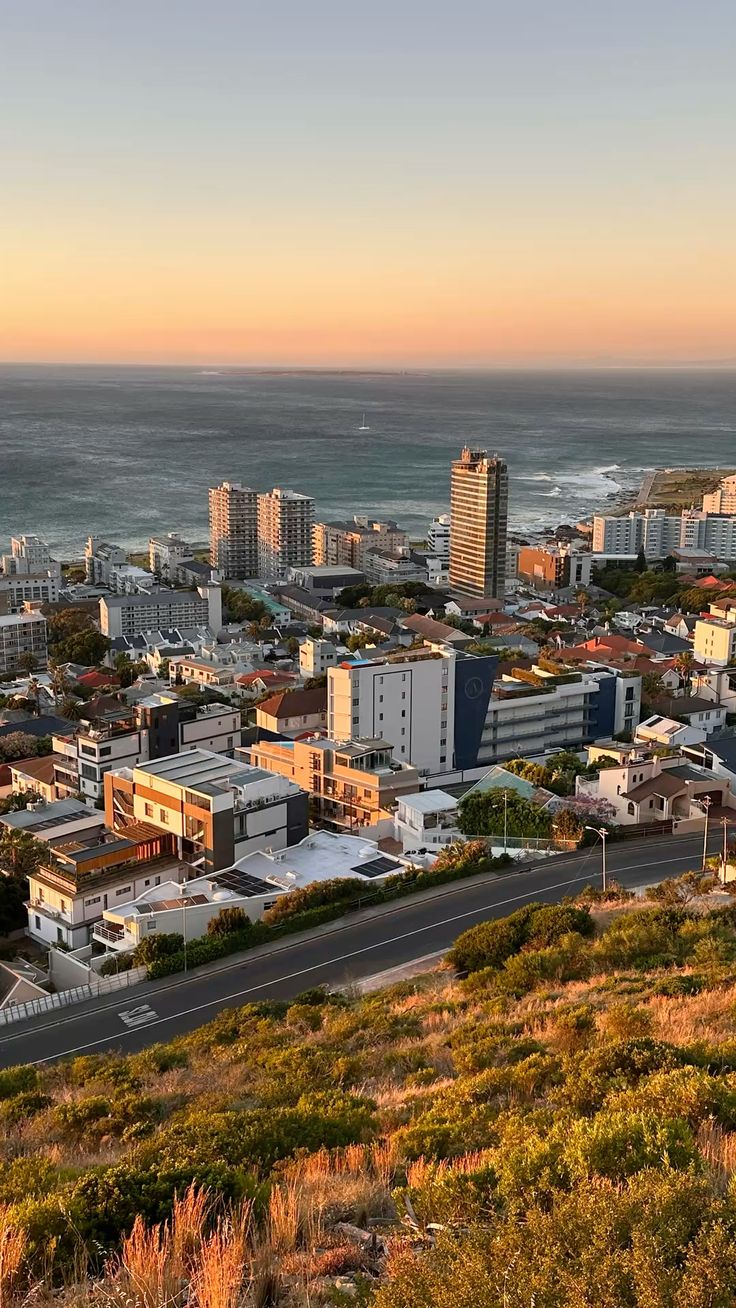 Aerial view of Cape Town coastline at Sea Point during golden hour with ocean and city buildings